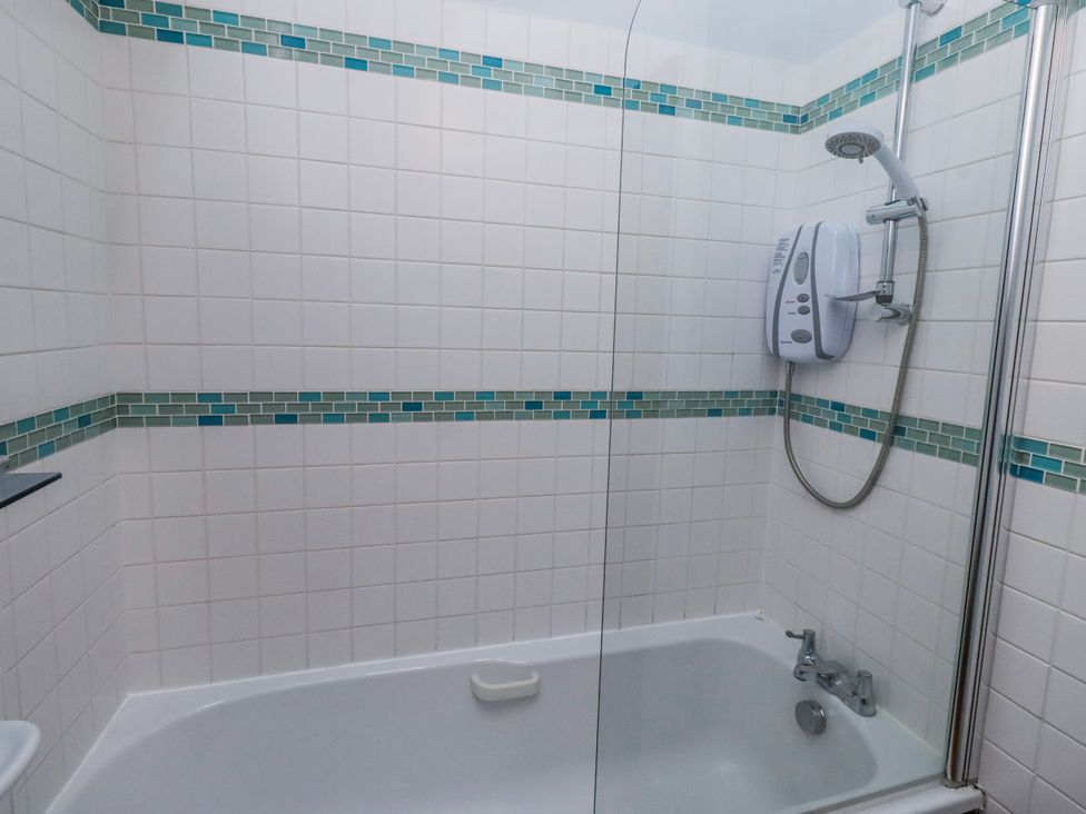 A bathroom with a bathtub and shower at No9 Budle Sands in Bamburgh