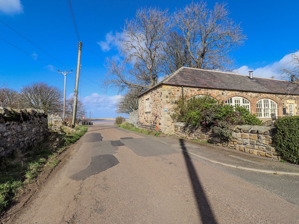 A street view with buildings and trees at No9 Budle Sands in Bamburgh