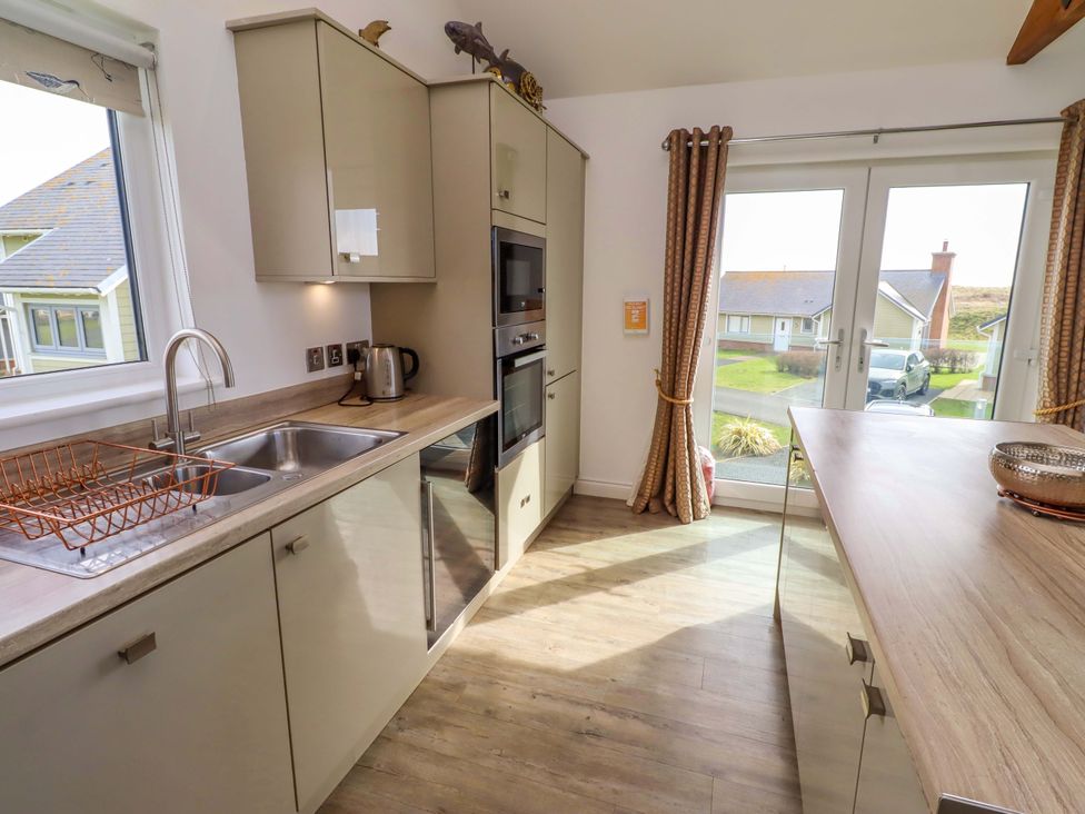 A kitchen with a sink and oven at Spindrifter in Beadnell