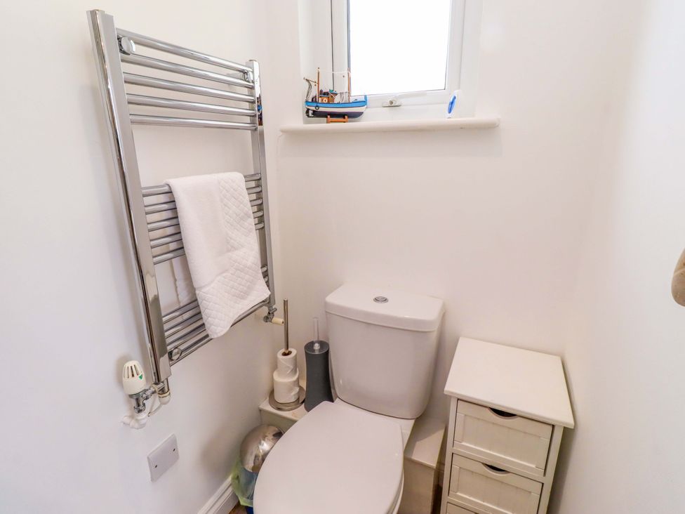 A bathroom with a toilet and towel rail at Spindrifter Beadnell