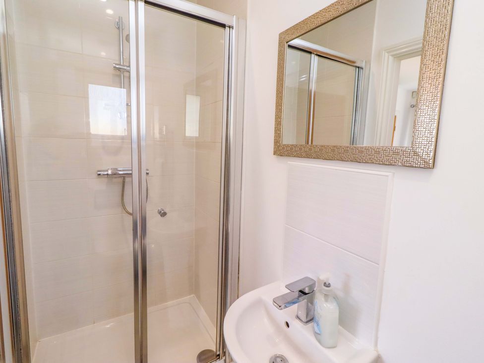 A bathroom with a shower and sink at Spindrifter in Beadnell