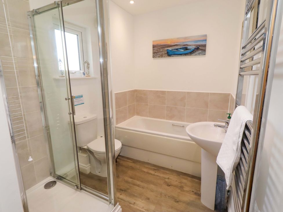 A bathroom with shower, bath, toilet and sink at Spindrifter Beadnell