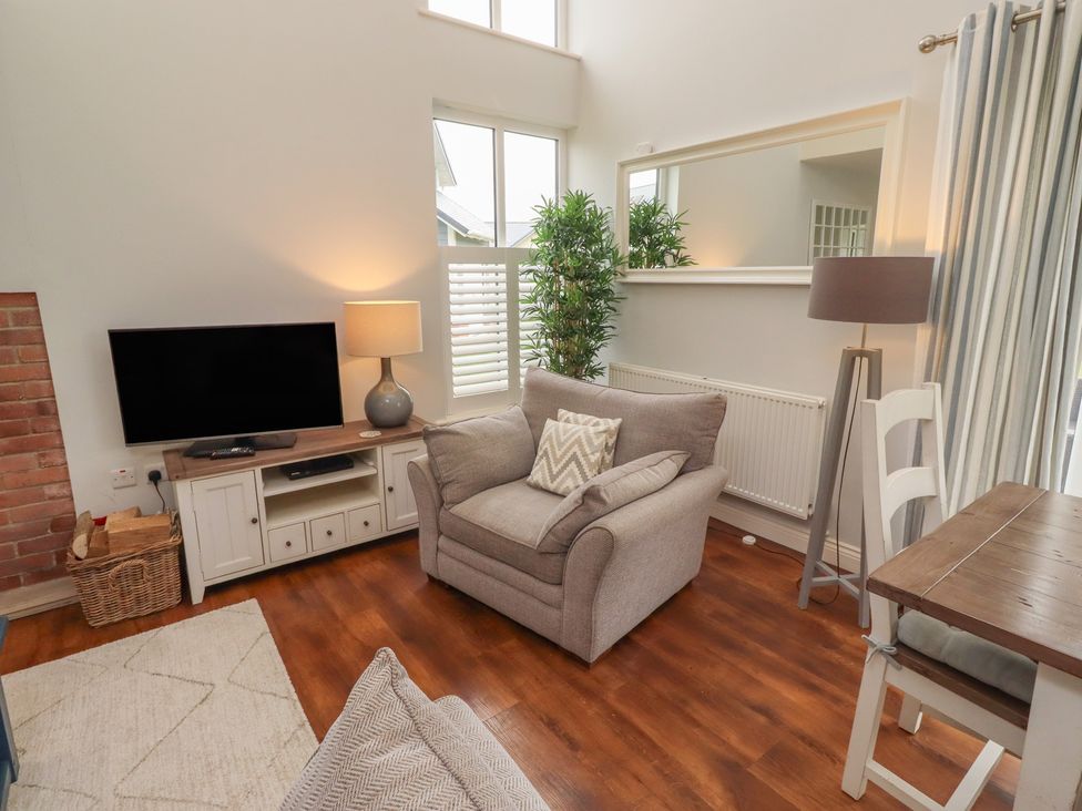 A living room with a sofa and television at The Beach Hut in Beadnell