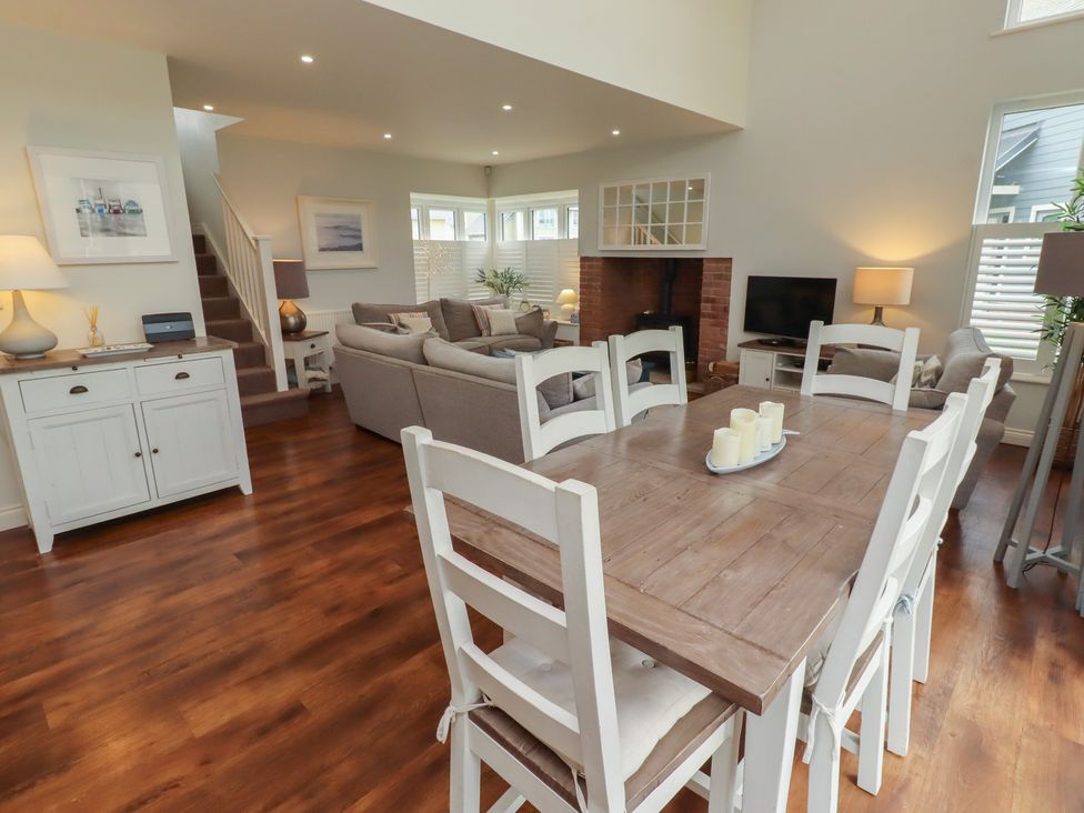 A living room with a dining table and sofa at The Beach Hut Beadnell