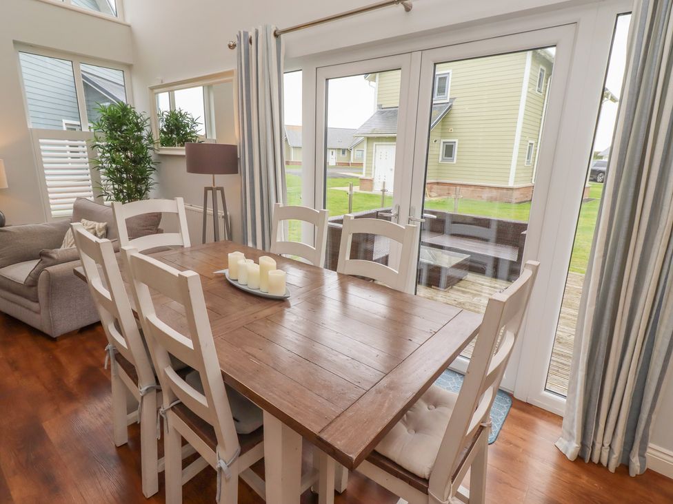 A dining room with a table and chairs at The Beach Hut in Beadnell