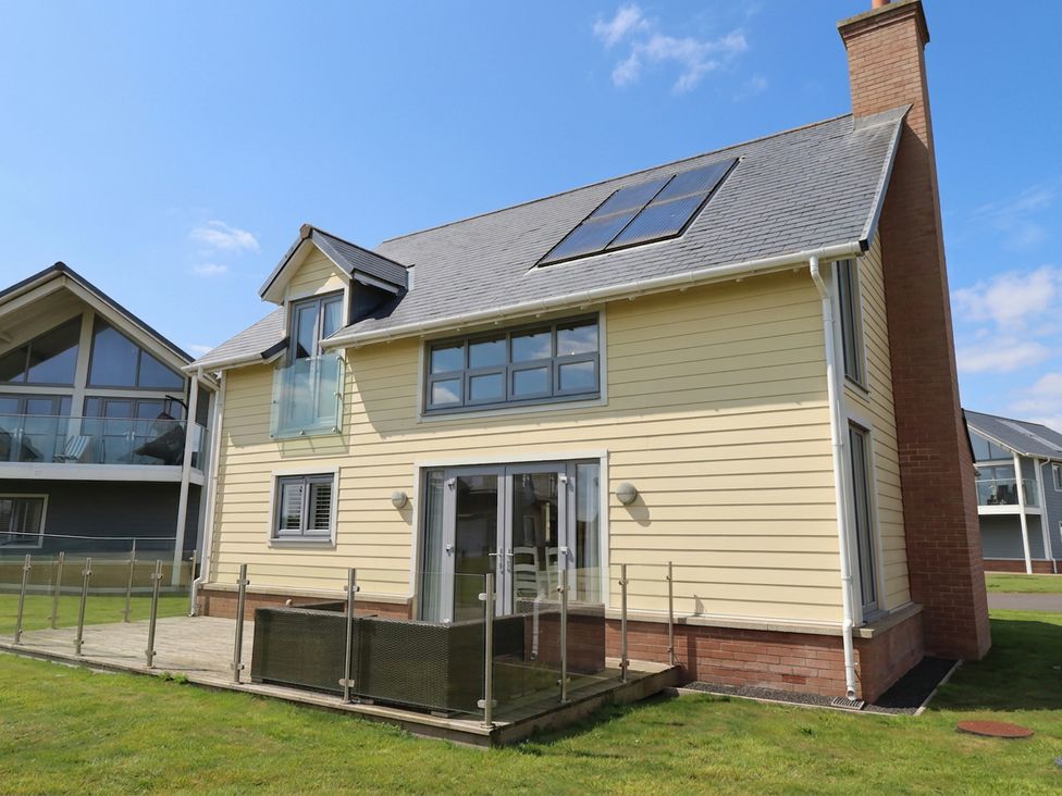A house with solar panels and decking at The Beach Hut Beadnell