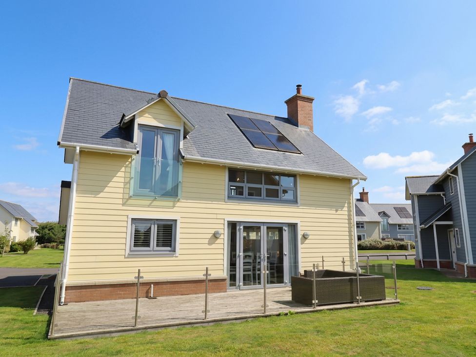 A house with solar panels and decking at The Beach Hut in Beadnell