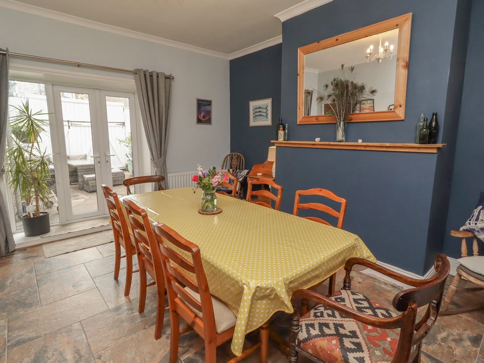 A dining room with a large table and sliding doors at Number Seventeen in Amble