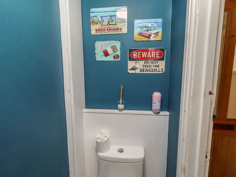 A bathroom with toilet and decorative signs at Number Seventeen Amble