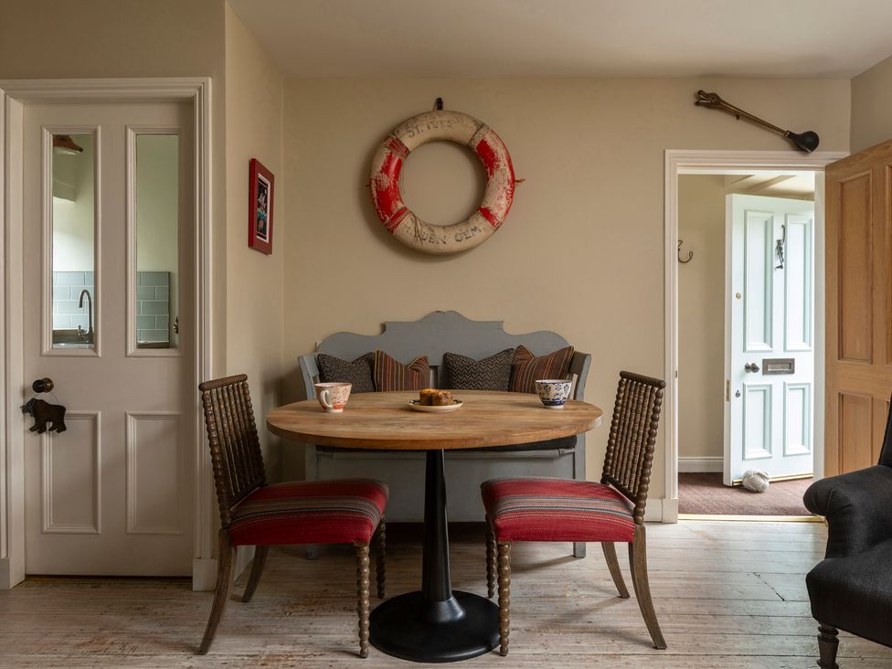 A dining room with a table and chairs at Sandpiper (Alnmouth)