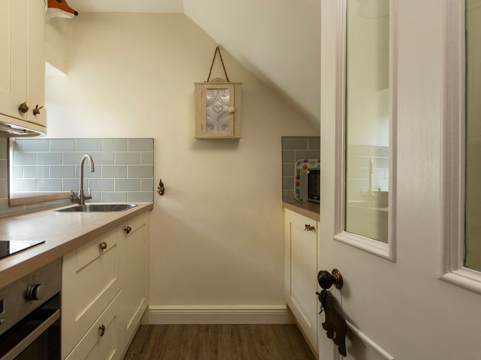 A kitchen with a sink and microwave at Sandpiper in Alnmouth