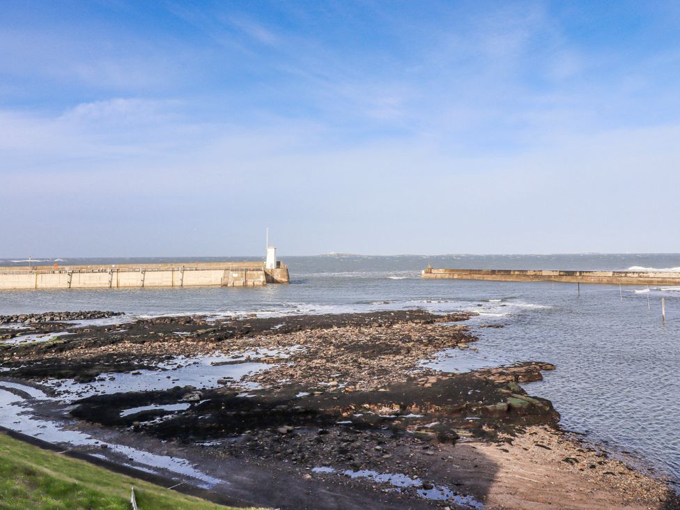 View of a pier and water at Cuddy's Holm in Seahouses