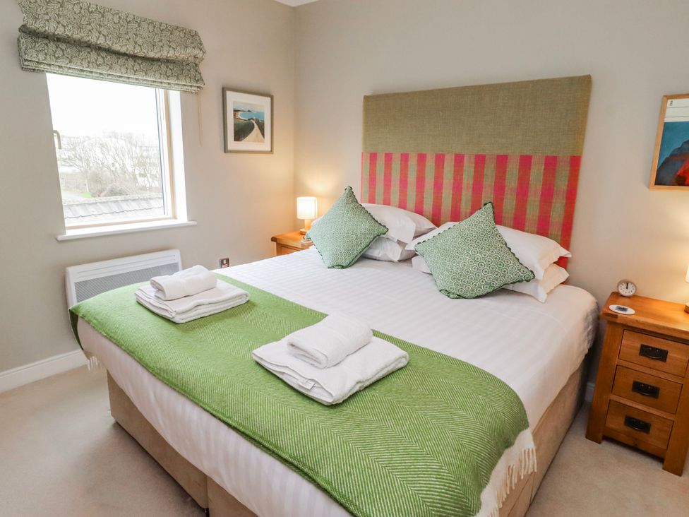 A bedroom with a double bed and bedside tables at Cuddy's Holm in Seahouses