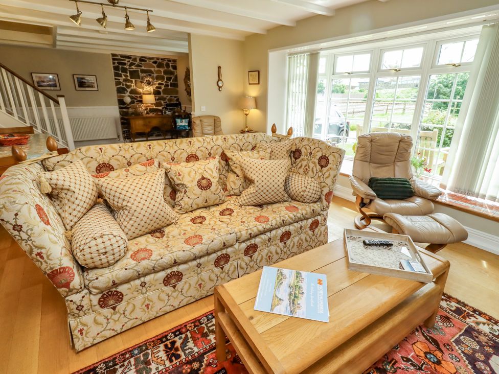 A living room with a sofa and coffee table at Coble Cottage in Craster