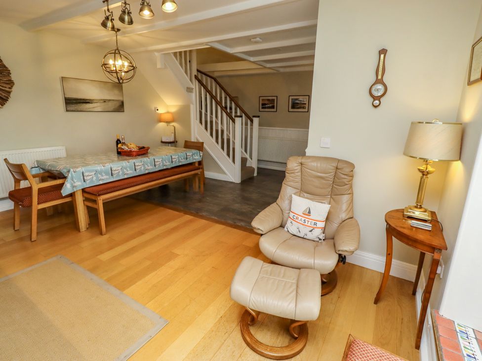 A dining room with a table and chairs at Coble Cottage Craster