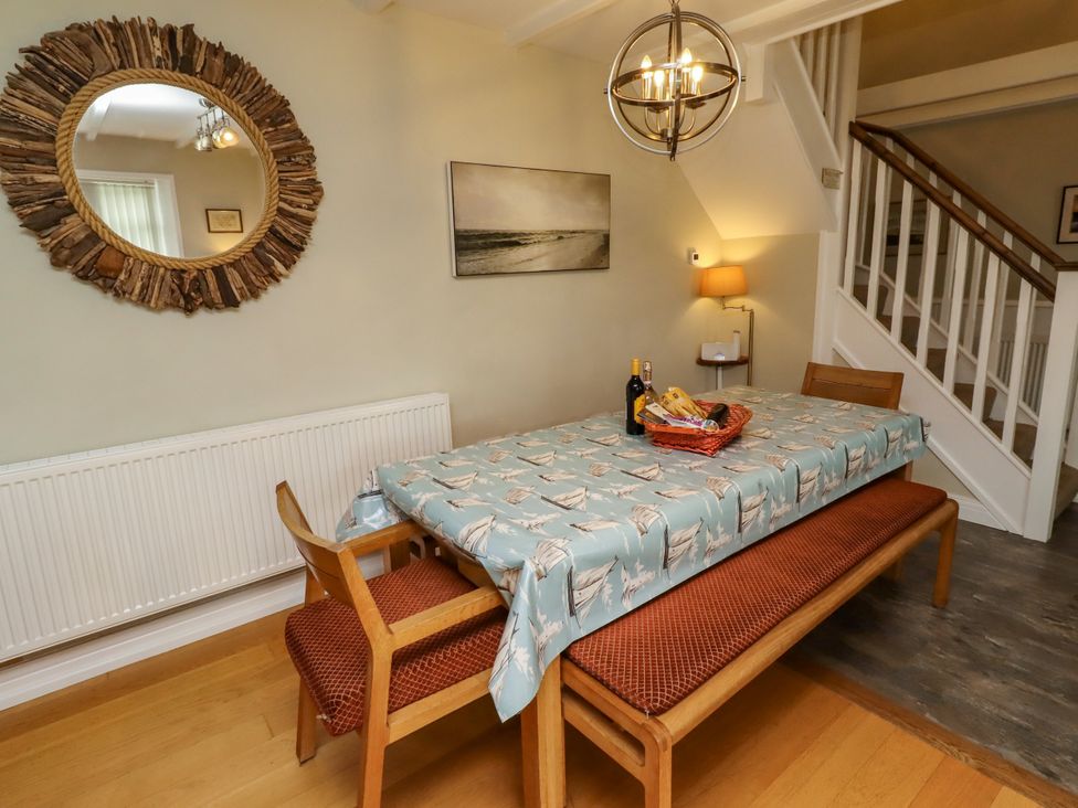 A dining room with a table and chairs at Coble Cottage in Craster