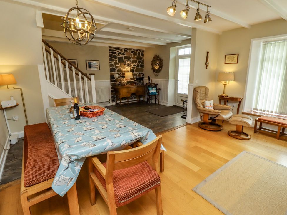 A dining room with a table and chairs at Coble Cottage Craster