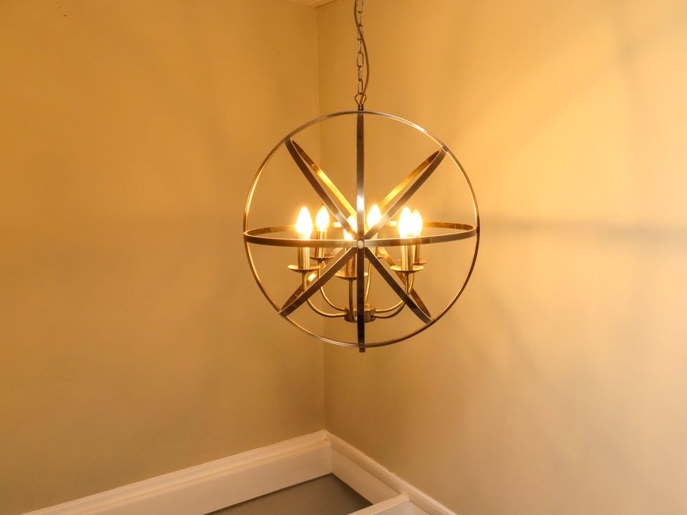 A chandelier with six lights at Coble Cottage in Craster