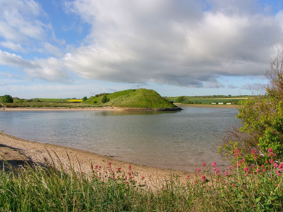 A landscape with water and an island at Percy Cottages No4 Alnmouth