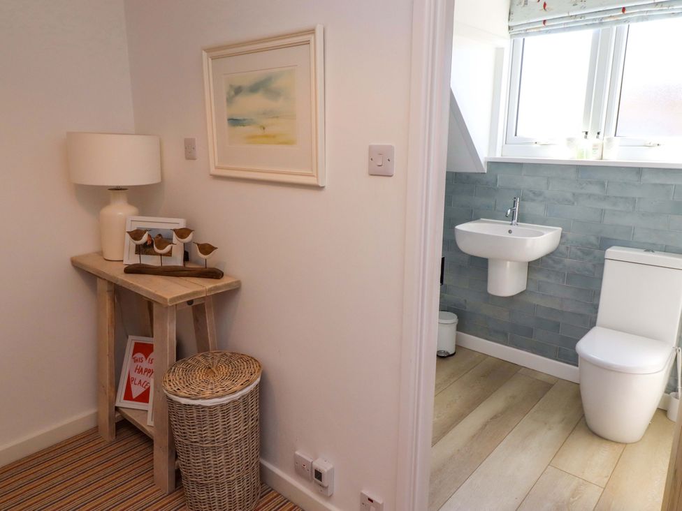 A bathroom with toilet and sink at Dunford Cottage Bamburgh
