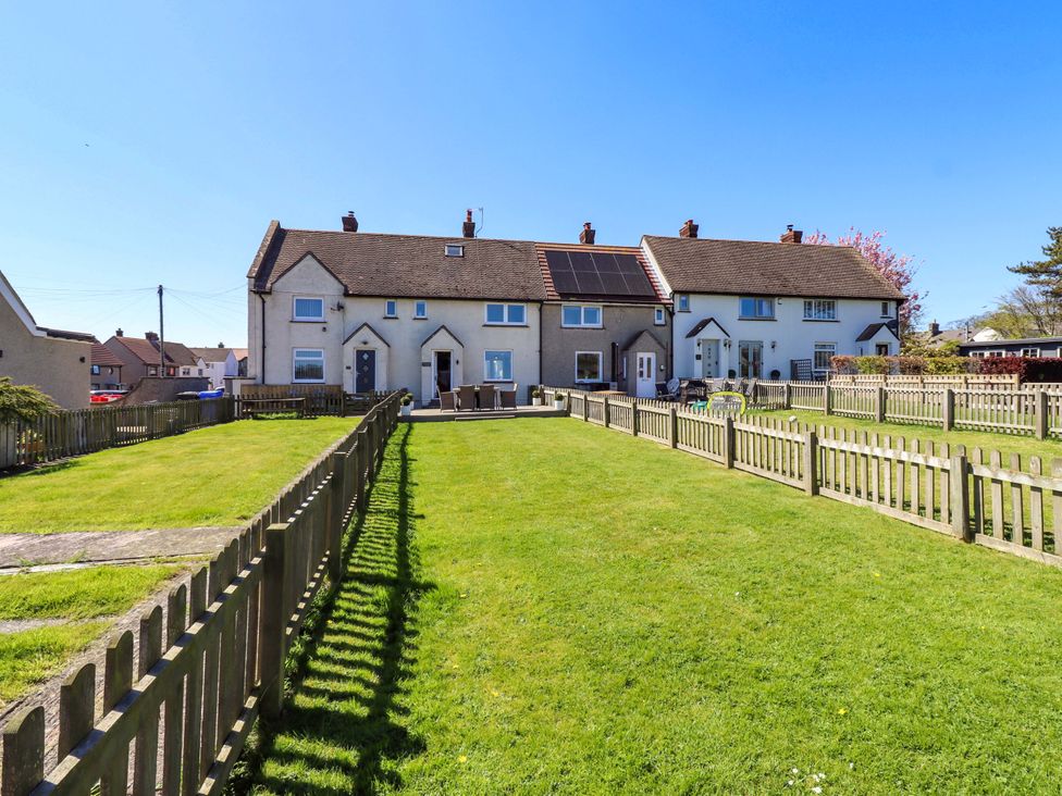 An outdoor area with houses and a garden at Dunford Cottage in Bamburgh