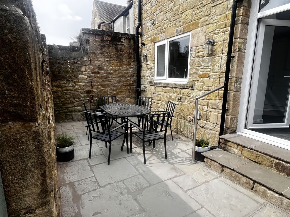 An outdoor area with a table and chairs at Longshore in Alnmouth