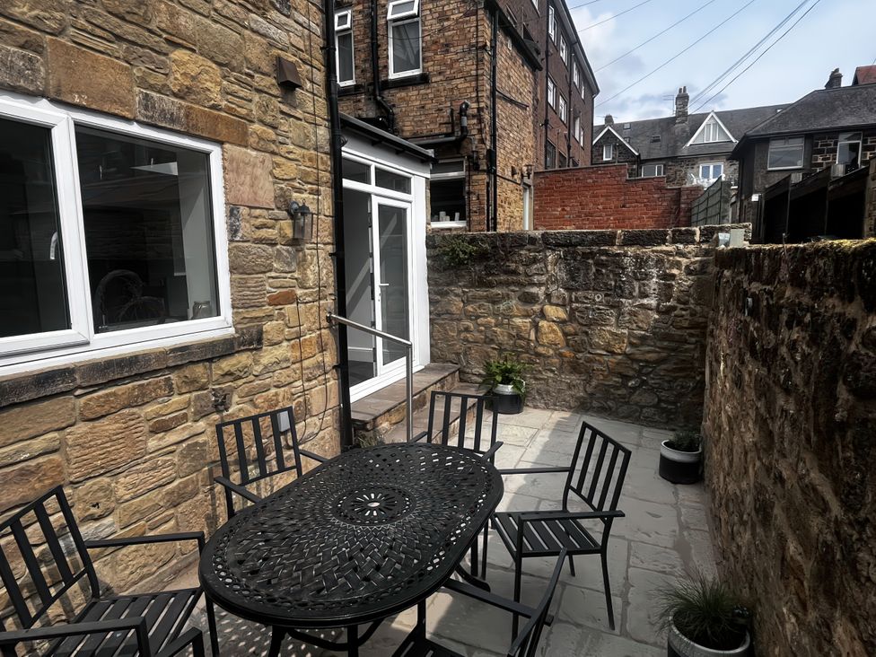 An outdoor area with a table and chairs at Longshore in Alnmouth