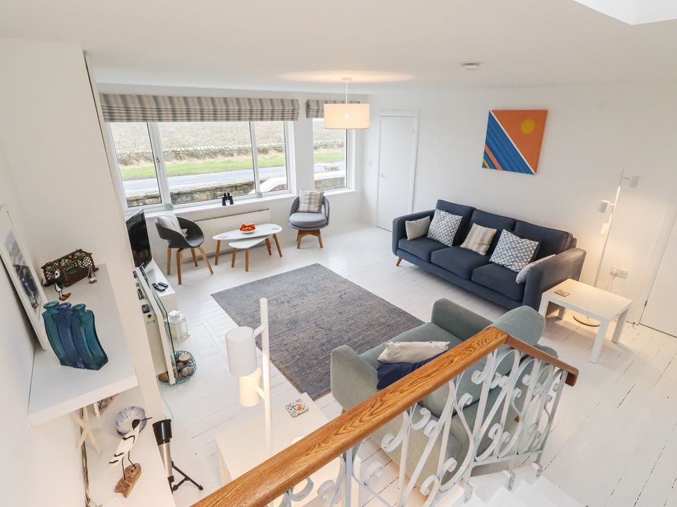 A living room with a sofa and coffee table at Dell Point in Beadnell