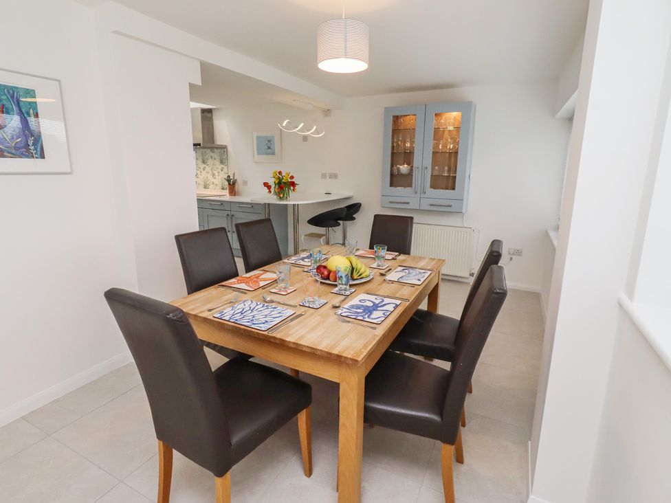 A dining room with a wooden table and chairs at Dell Point in Beadnell