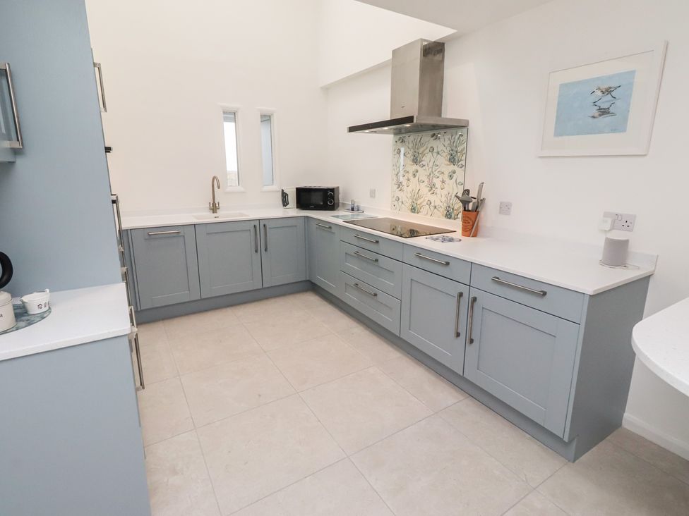 A kitchen with cabinets and a sink at Dell Point in Beadnell