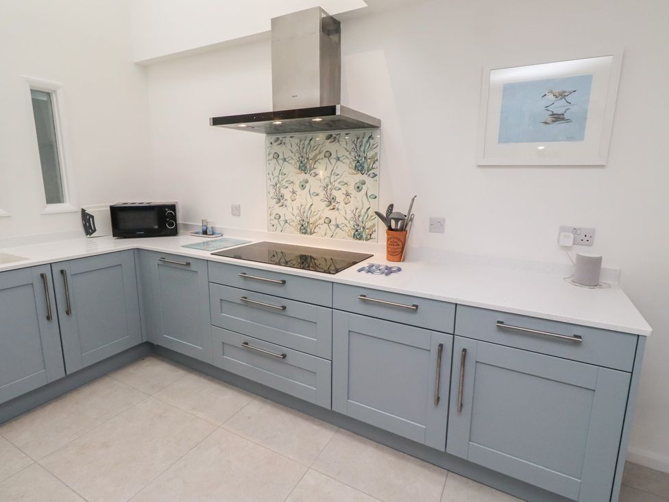 A kitchen with appliances and cabinets at Dell Point Beadnell