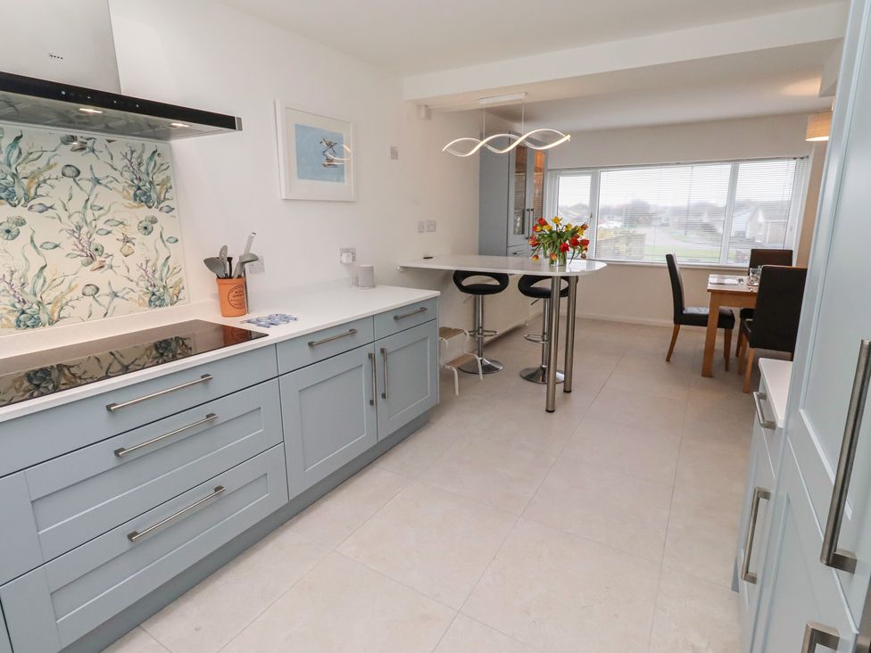 A kitchen with a countertop and dining area at Dell Point Beadnell