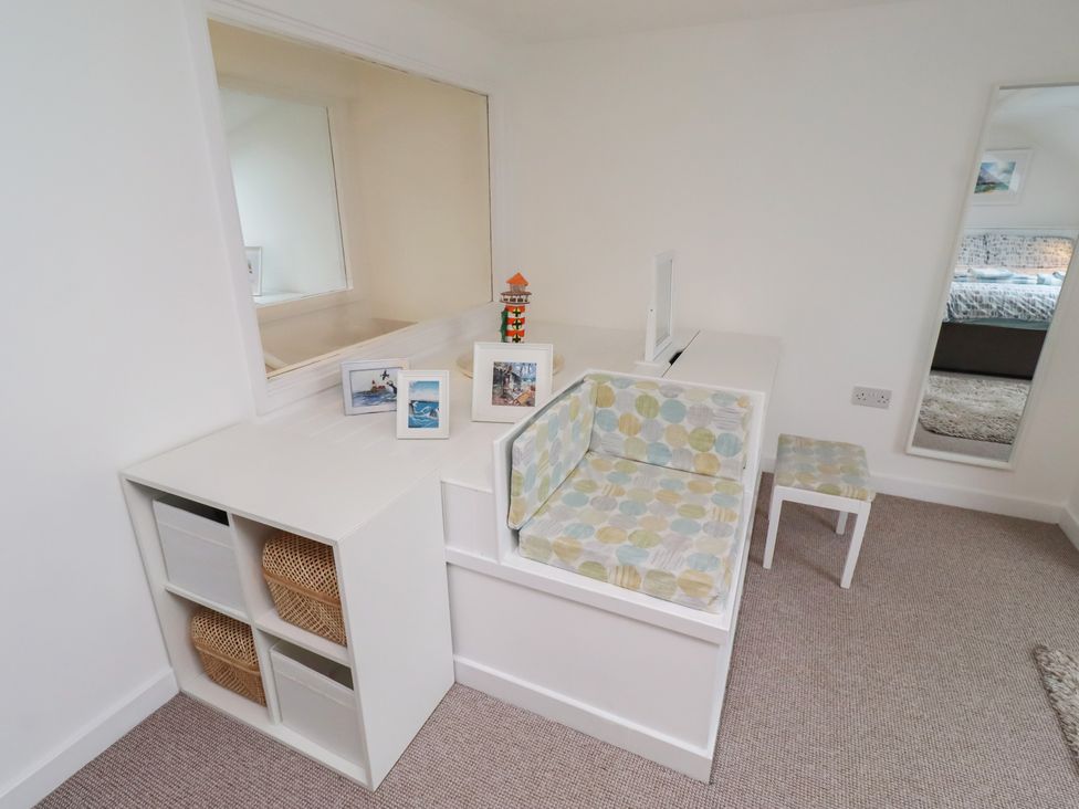 A room with a seating area and mirror at Dell Point Beadnell