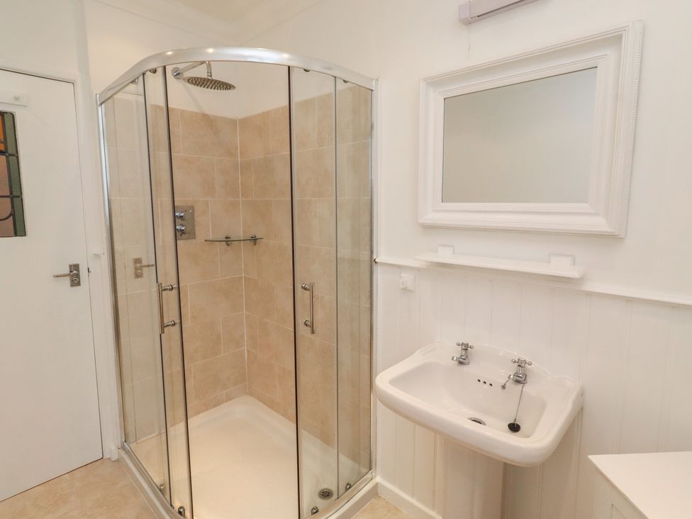 A bathroom with a shower and sink at Dell Point in Beadnell
