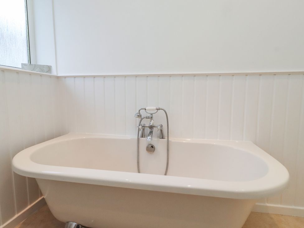 A bathroom with a freestanding bath tub and faucet at Dell Point in Beadnell
