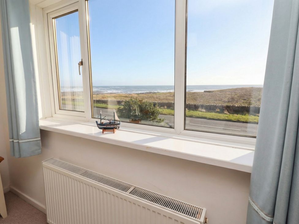 A living room window with a view of the sea at Dell Point in Beadnell