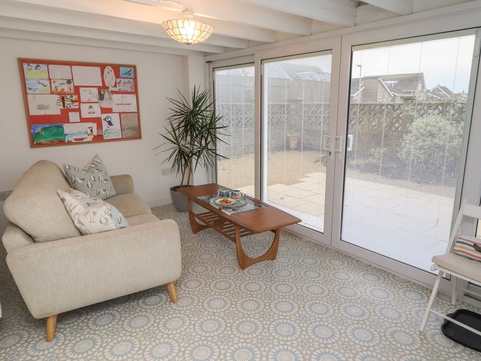 A snug with a sofa and coffee table at Dell Point in Beadnell