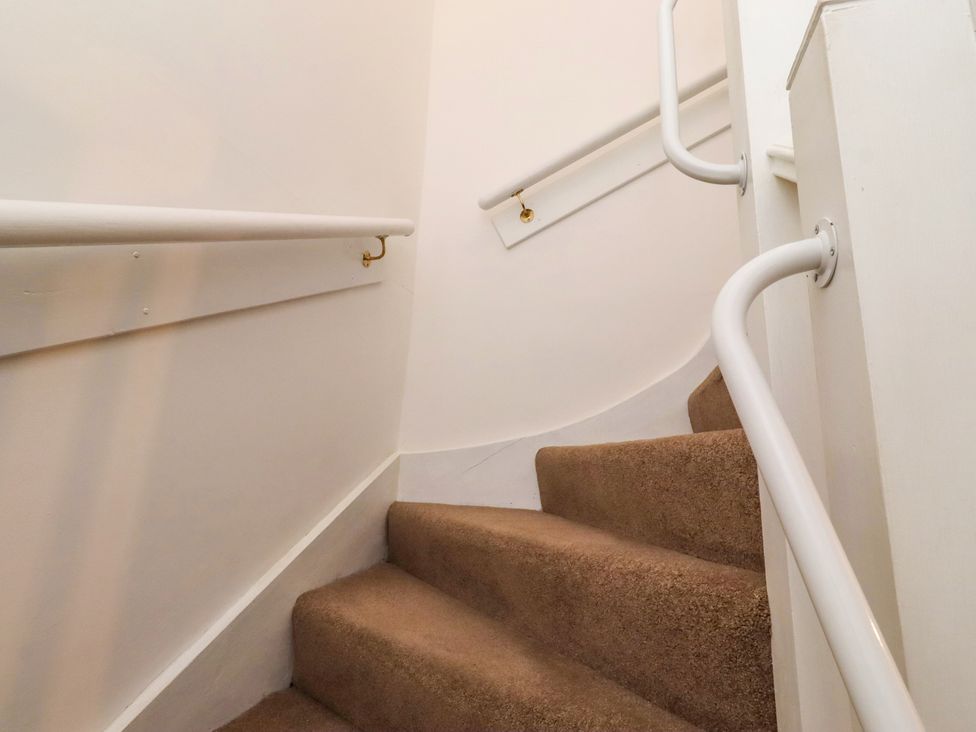 A staircase with a handrail at the Old Bakery No2 in Seahouses