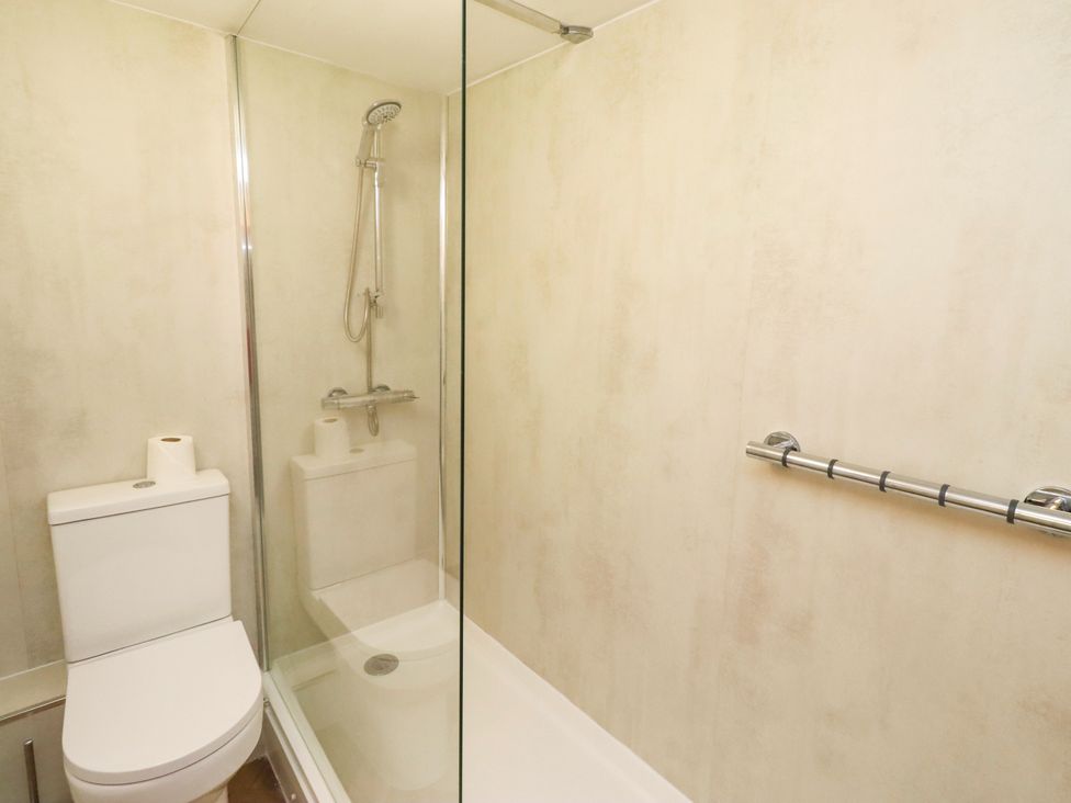 A bathroom with a shower and toilet at Old Bakery No2 in Seahouses