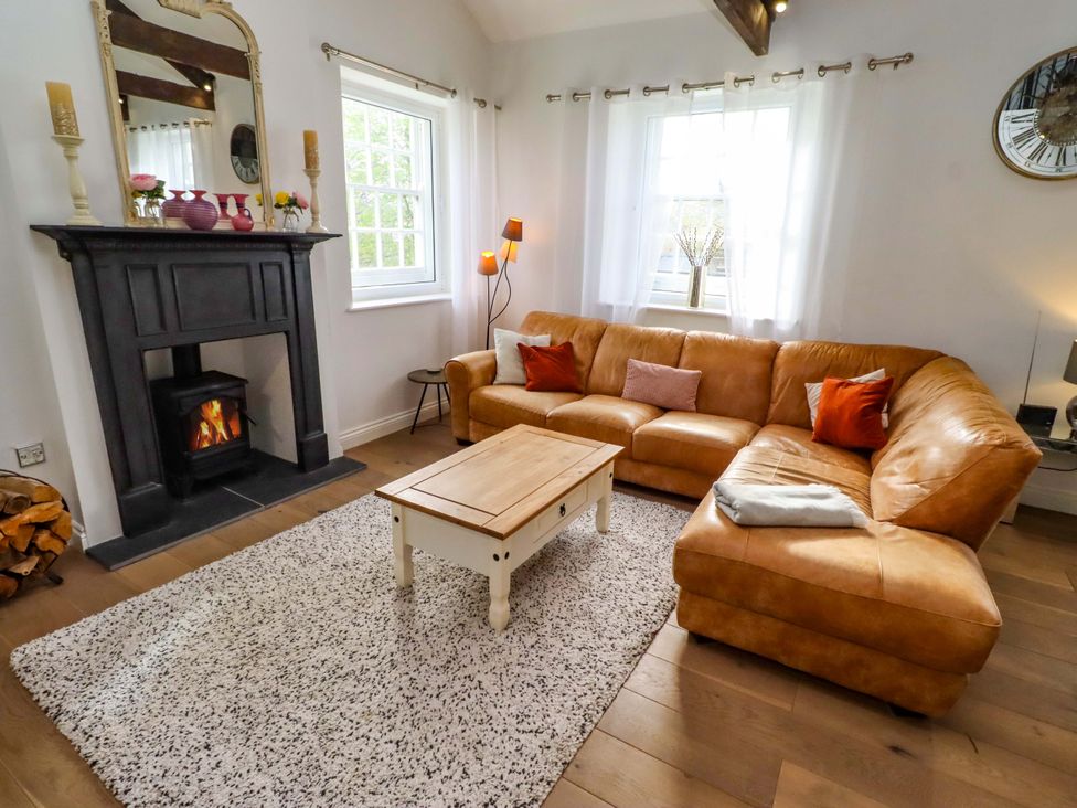 A living room with a sofa and a coffee table at Treetops, Alnwick