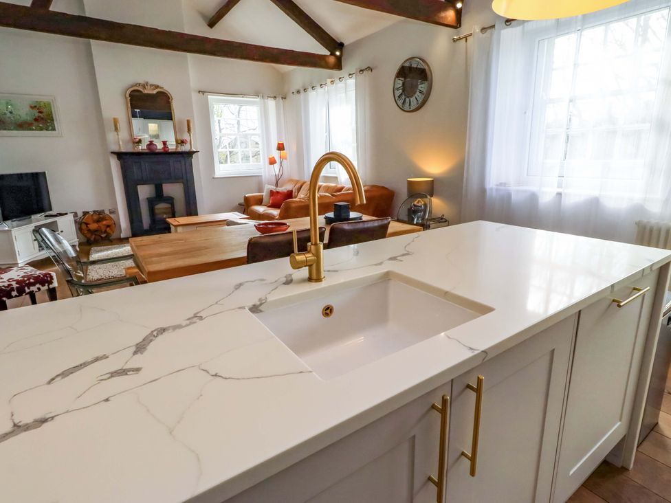 A kitchen with a sink and countertop at Treetops, Alnwick