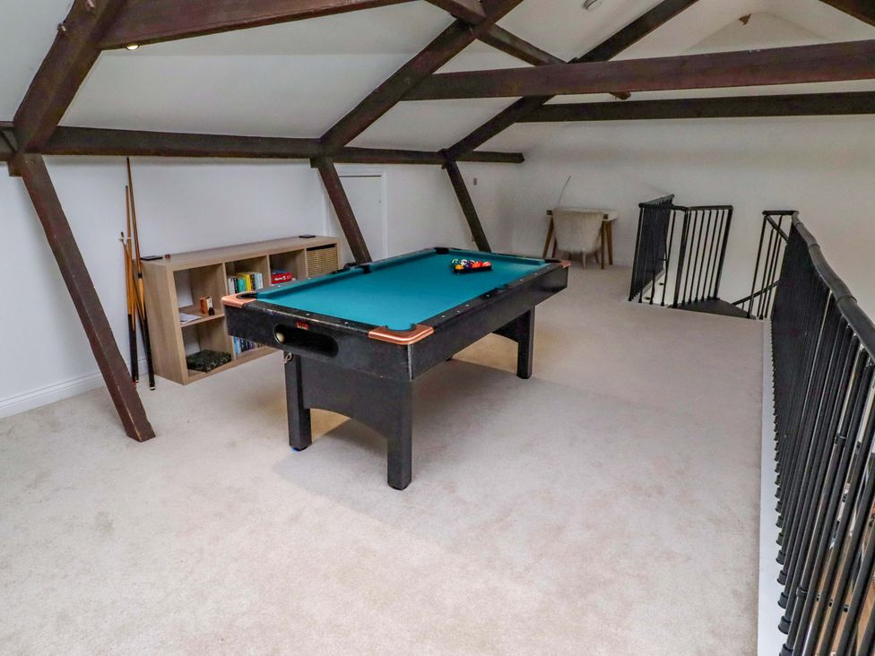 A game room with a pool table and a bookshelf at Treetops, Alnwick