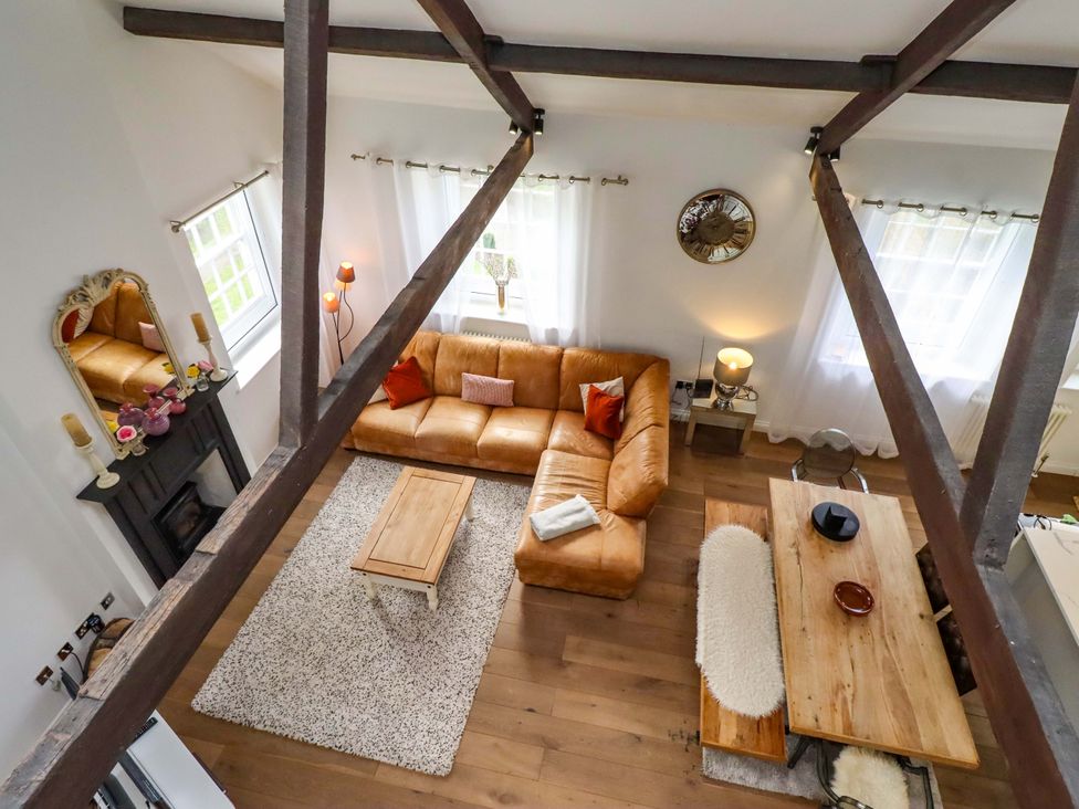A living room with sofa, coffee table and dining table at Treetops, Alnwick
