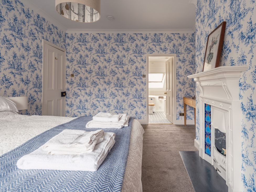 A bedroom with a bed and towels on a blanket at Westhill House in Warkworth