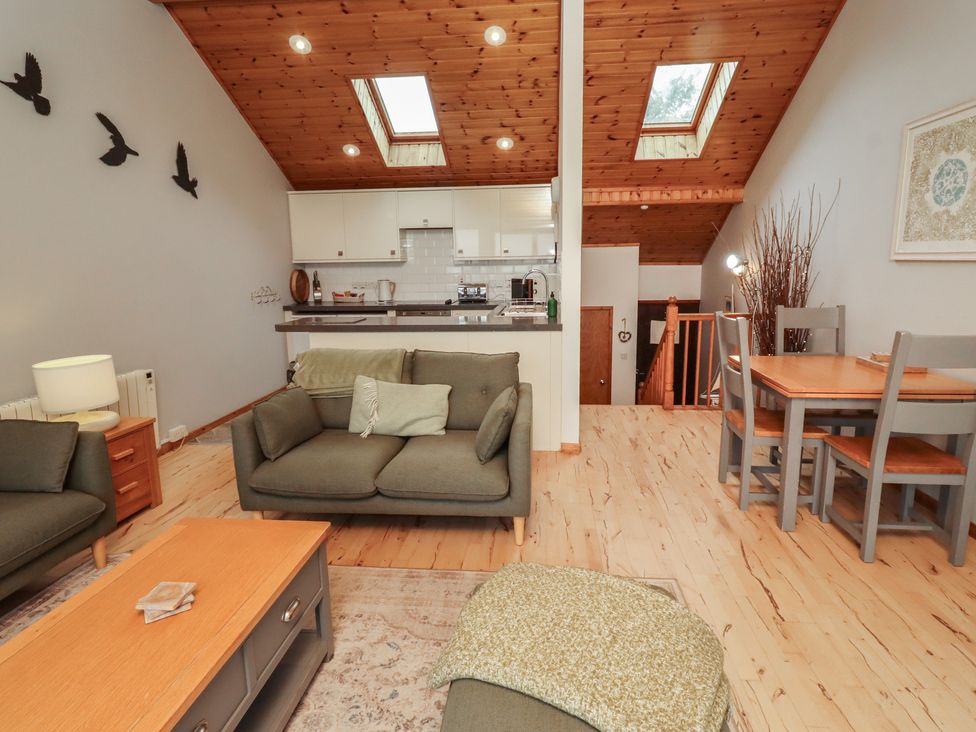 A living room with a sofa and dining table at Links View in Embleton