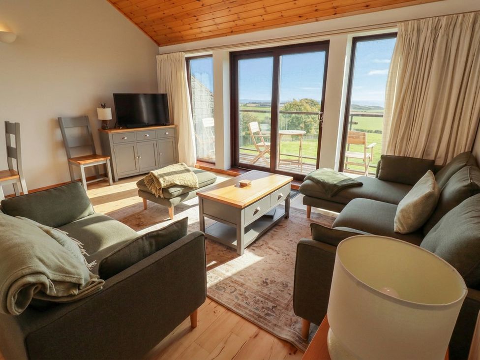 A living room with a sofa and tv at Links View Embleton
