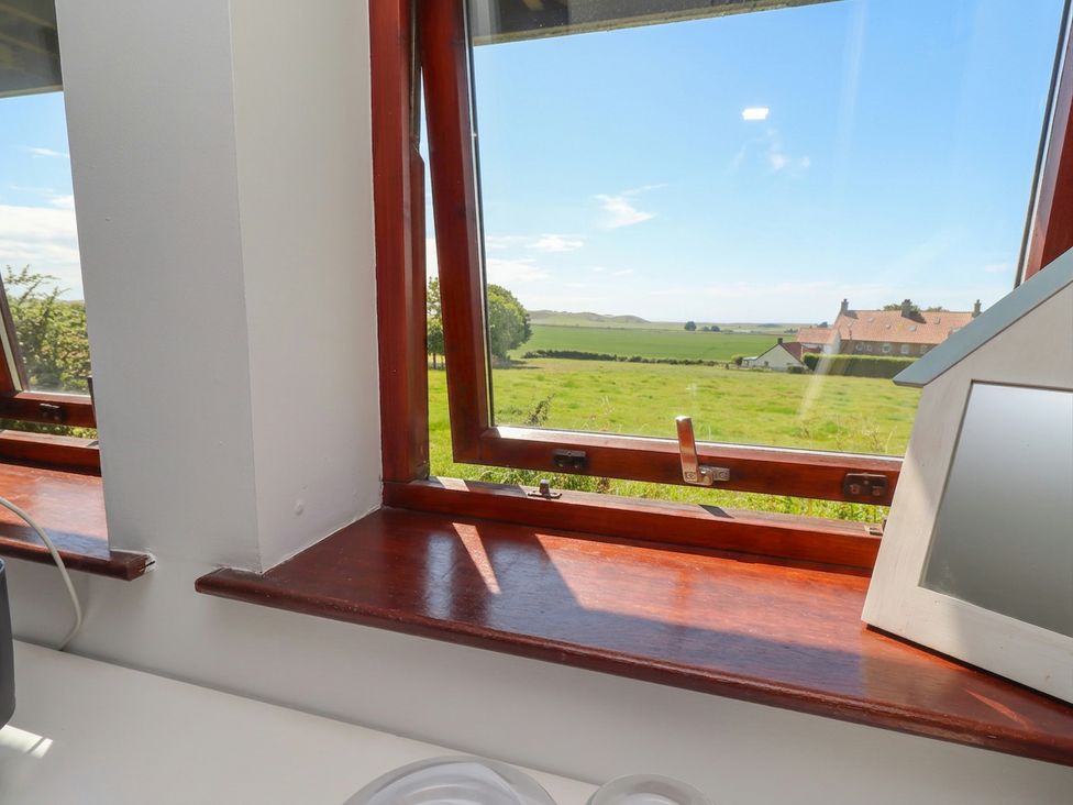 A view from a window showing a landscape and houses at Links View in Embleton