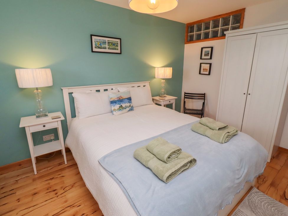 A bedroom with a bed and nightstand at Links View in Embleton