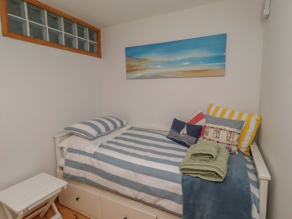 A bedroom with a bed against a wall at Links View, Embleton