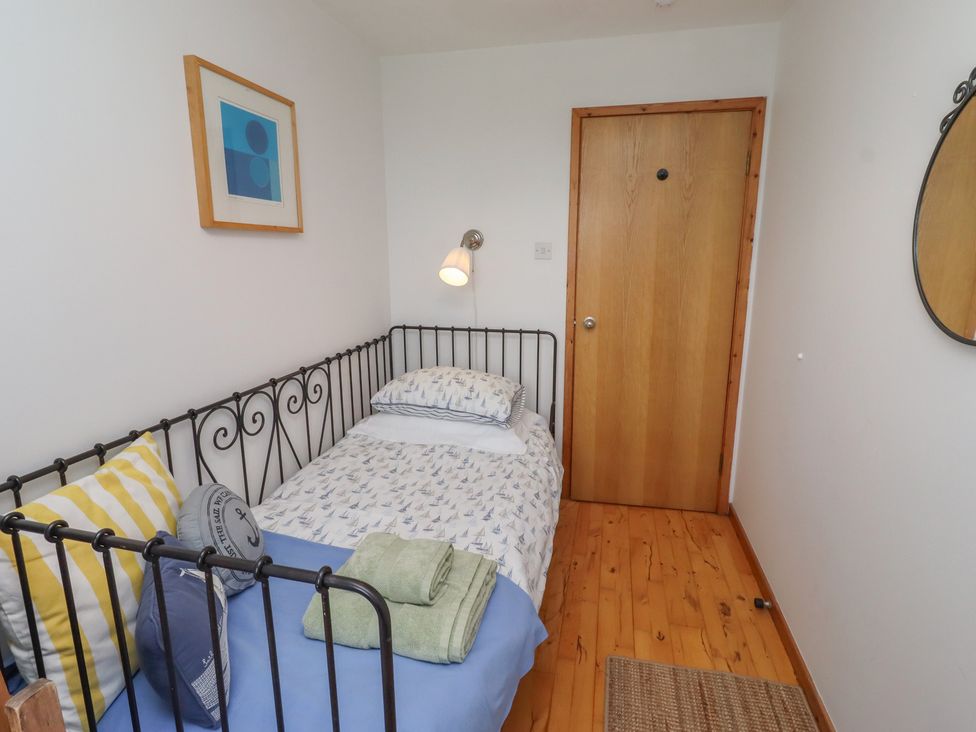 A bedroom with a bed and door at Links View in Embleton